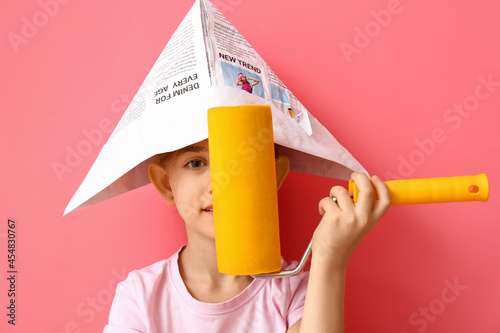 Little girl with paint roll...