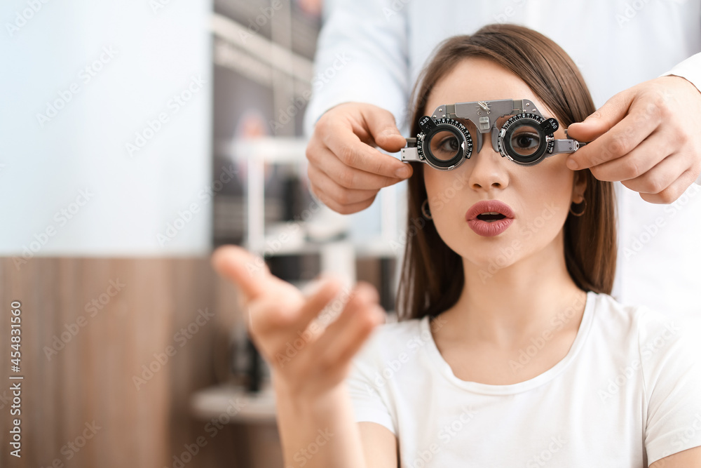 Young woman visiting ophthalmologist in clinic Young woman visiting ophthalmologist in clinic
