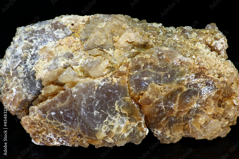 Sample of untreated chalcedony nodule with clay impurities on a black background close up. Deposit Russia Sample of untreated chalcedony nodule with clay impurities on a black background close up. Deposit Russia