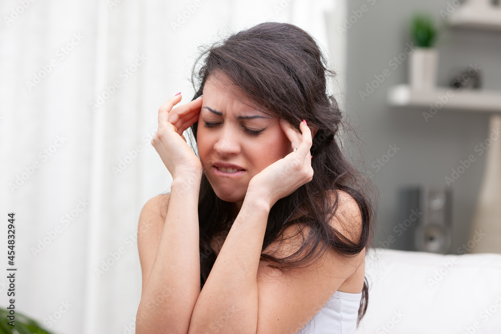 Young woman suffering from a migraine or headache Young woman suffering from a migraine or headache