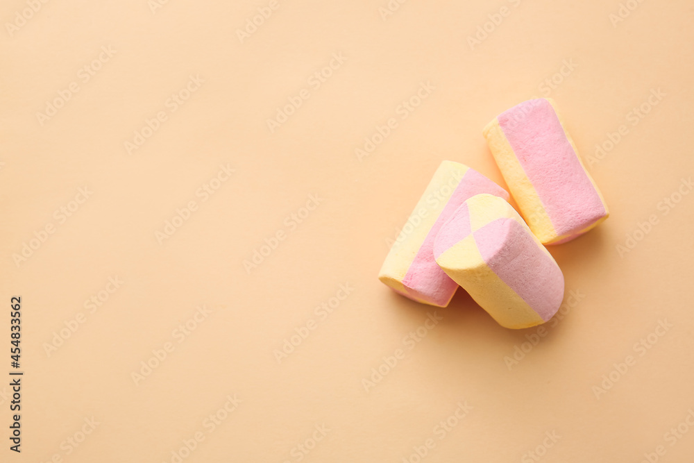 Tasty marshmallows on color background