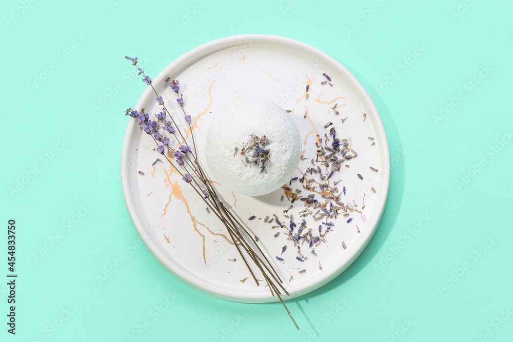 Plate with bath bomb and lavender flowers on color background Plate with bath bomb and lavender flowers on color background