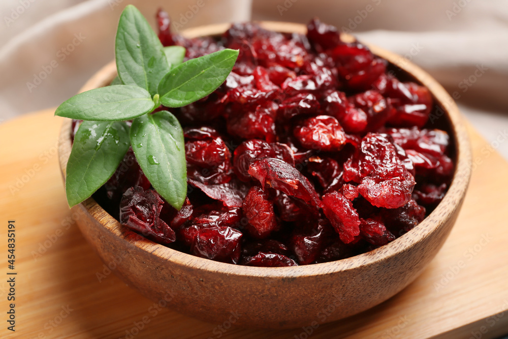 Bowl with tasty dried cranberries on table, closeup Bowl with tasty dried cranberries on table, closeup