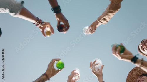 happy group of friends making toast celebrating friendship reunion drinking enjoying weekend gathering having fun party celebration relaxing on summer day view from below 4k  photo
