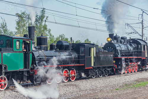 Steam retro train departs from the station.