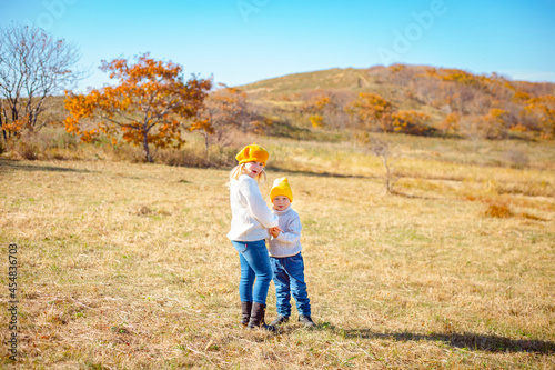 little brother and sister in yellow grass