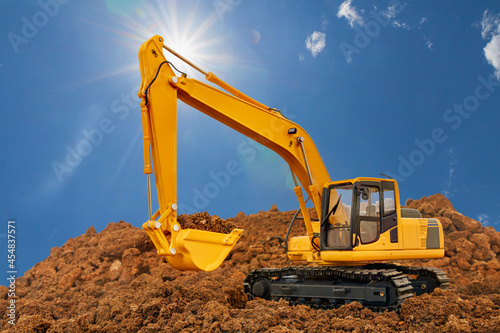 Crawler Excavator digging the soil In the construction site area on blue sky and sunlight background