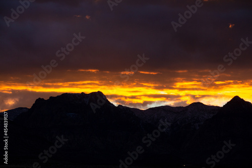 Dramatic sunset with clouds over desert canyon