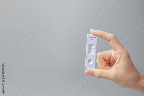 Wallpaper Mural man holding Rapid Antigen Test kit with Negative result during swab COVID-19 testing. Coronavirus Self nasal or Home test, Lockdown and Home Isolation concept Torontodigital.ca