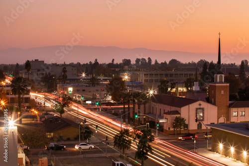 Canvas Print Evening traffic streams through downtown Bakersfield, California, USA, at sunset