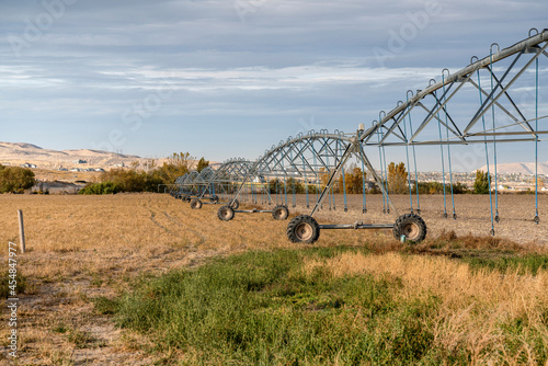 Wheel-mounted center-pivot irrigation at the field near the residential area