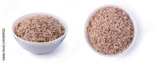 set of flattened rice also known as parched or beaten rice in a bowl, parboiled and dried, flakes like rice commonly called poha or aval in indian subcontinent, taken from different angles on white