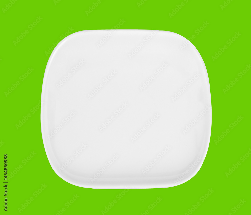 white plate isolated on green background white plate isolated on green background