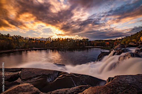 sunset over a waterfall in autumn