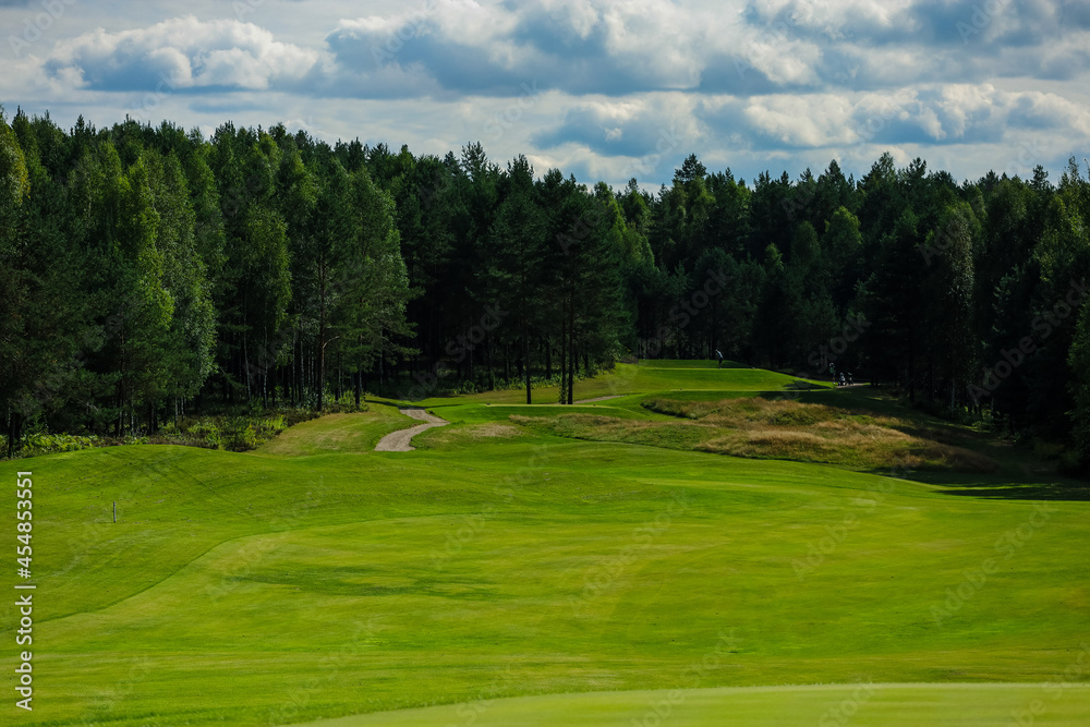 Golf course, landscape, green grass on the background of the forest and a bright sky with clouds. High quality photo Golf course, landscape, green grass on the background of the forest and a bright sky with clouds. High quality photo