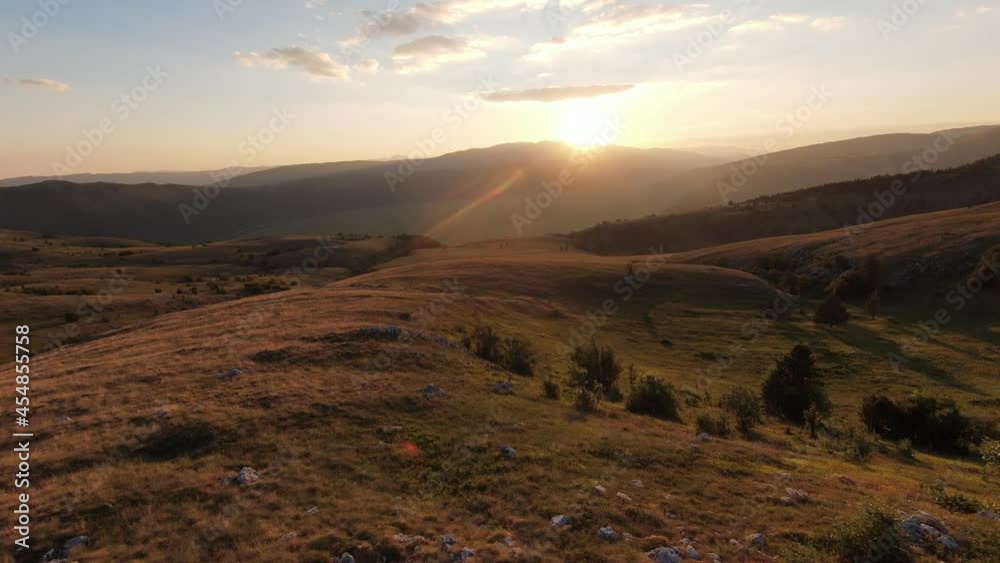 Extreme close flight over mountain peaks on sunset. Aerial shot on fpv sport drone sunny landscape with mountain hilly terrain. Dynamic cinematic view. Extreme close flight over mountain peaks on sunset. Aerial shot on fpv sport drone sunny landscape with mountain hilly terrain. Dynamic cinematic view.