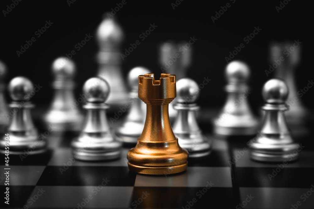 Gold Rook or Castle Tower Chess piece closeup on chess board game. Elite Company leader concept. Gold Rook or Castle Tower Chess piece closeup on chess board game. Elite Company leader concept.