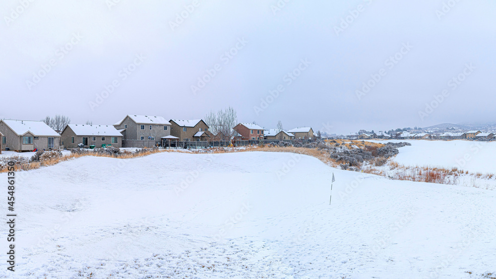 Pano White snowy view of a town with large houses covered in snow