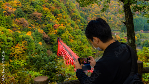 young man reading book in park