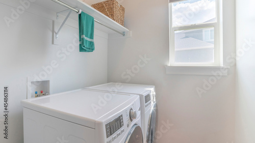 Pano Clean laundry room with one window and two laundry machines