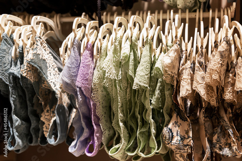 Lace panties on hangers in the store. Large selection of beautiful lingerie. Side view. Close-up.