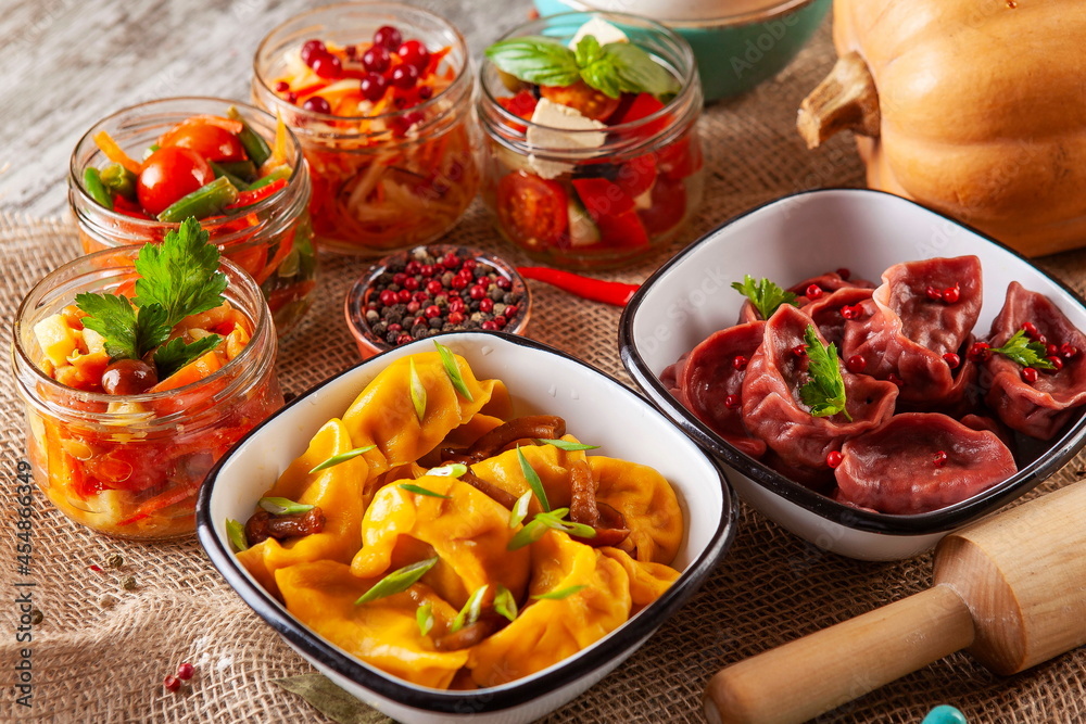 yellow and red dumplings, dumplings on a wooden board yellow and red dumplings, dumplings on a wooden board