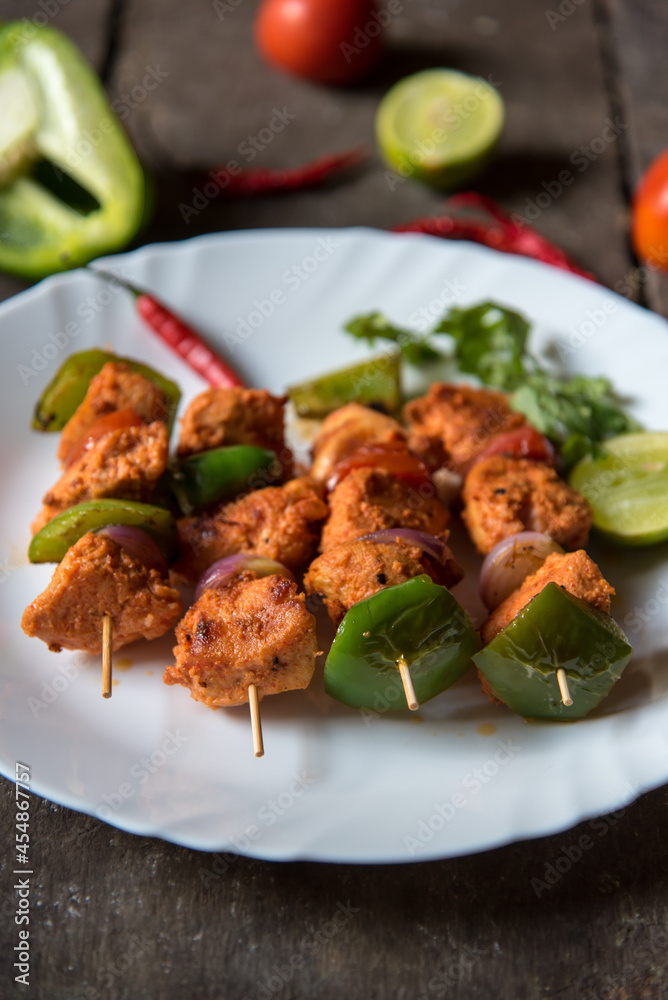 Close up of grilled chicken wings with vegetables in skewers. Selective focus. Close up of grilled chicken wings with vegetables in skewers. Selective focus.