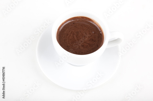 small cup of hot chocolate on a white plate in a white cup