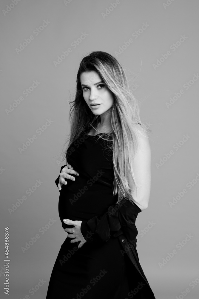 Fototapeta premium Beautiful pregnant young woman in studio
