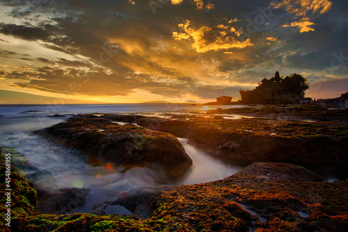 beautiful landscape of hinduism temple located in Tanah Lot Bali Bali at sunset with sun light sky background