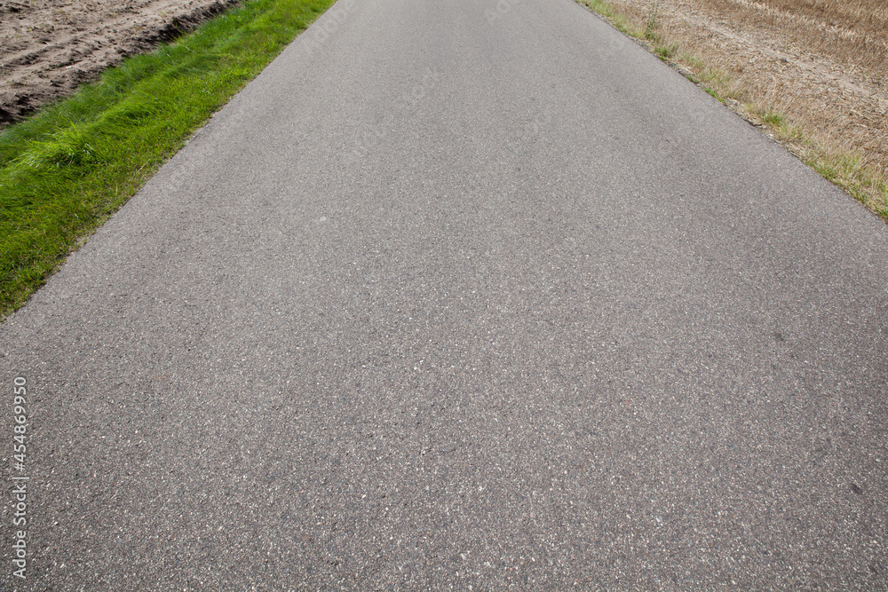 Narrow paved country road and farmland. Narrow paved country road and farmland.