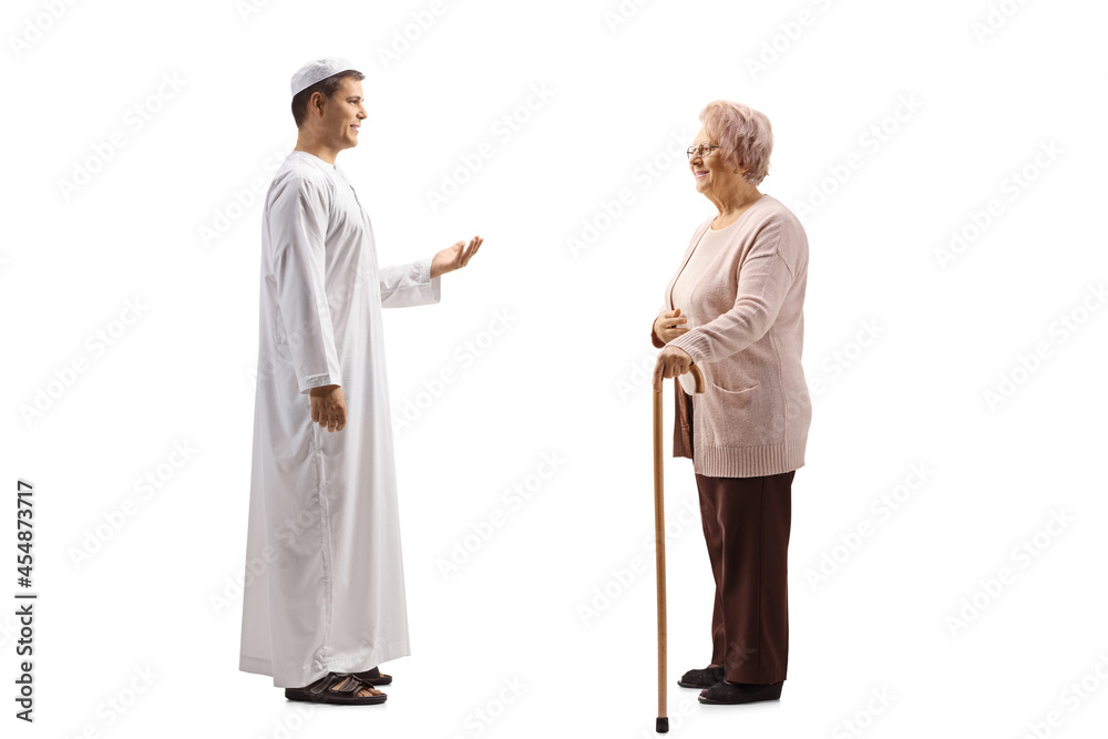 Full length profile shot of a an elderly woman and a young man in ethnic clothes having a conversation