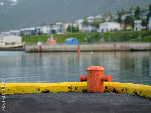 Orange bollard at the small fishing village Siglufjördur in north Iceland.