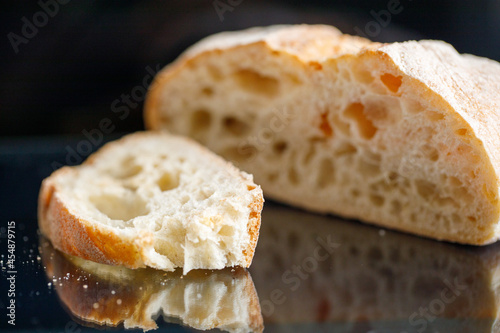 sliced white bread on dark glass background