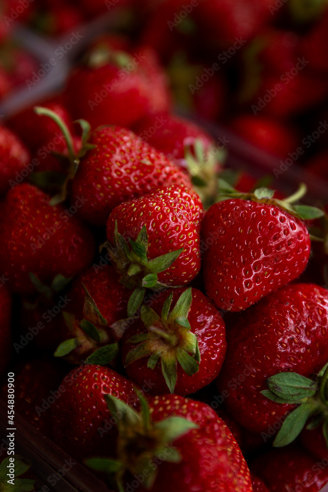 Lots of fresh strawberries. Vitamins and health from nature. Close-up. Vertical. Lots of fresh strawberries. Vitamins and health from nature. Close-up. Vertical.