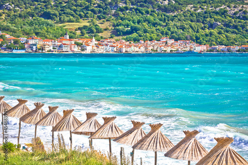 Turquoise beach in Baska sun shades view, Island of Krk, Croatia.