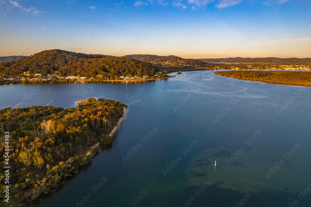 Fototapeta premium Late afternoon aerial waterscape over the bay with high clouds