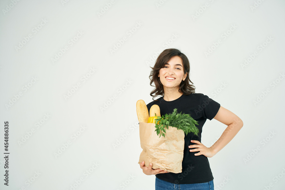 brunette with a package of groceries healthy food supermarket delivery brunette with a package of groceries healthy food supermarket delivery