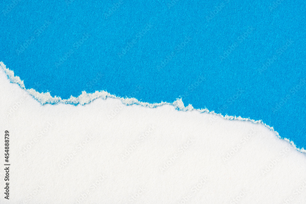 Blue paper torn to reveal white paper background Blue paper torn to reveal white paper background