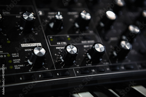Analog synthesizer device. Professional audio equipment for electronic music production in sound recording studio.  photo