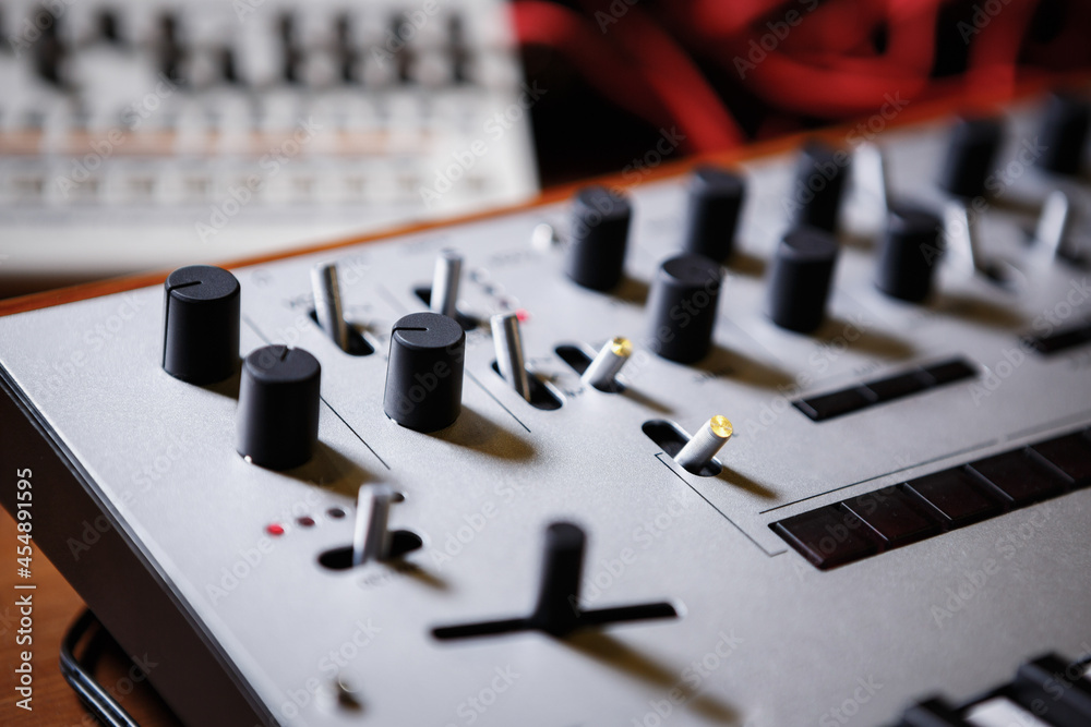 Professional synthesizer device for electronic music production. Compose new musical tracks with electronic midi controller in sound recording studio Professional synthesizer device for electronic music production. Compose new musical tracks with electronic midi controller in sound recording studio