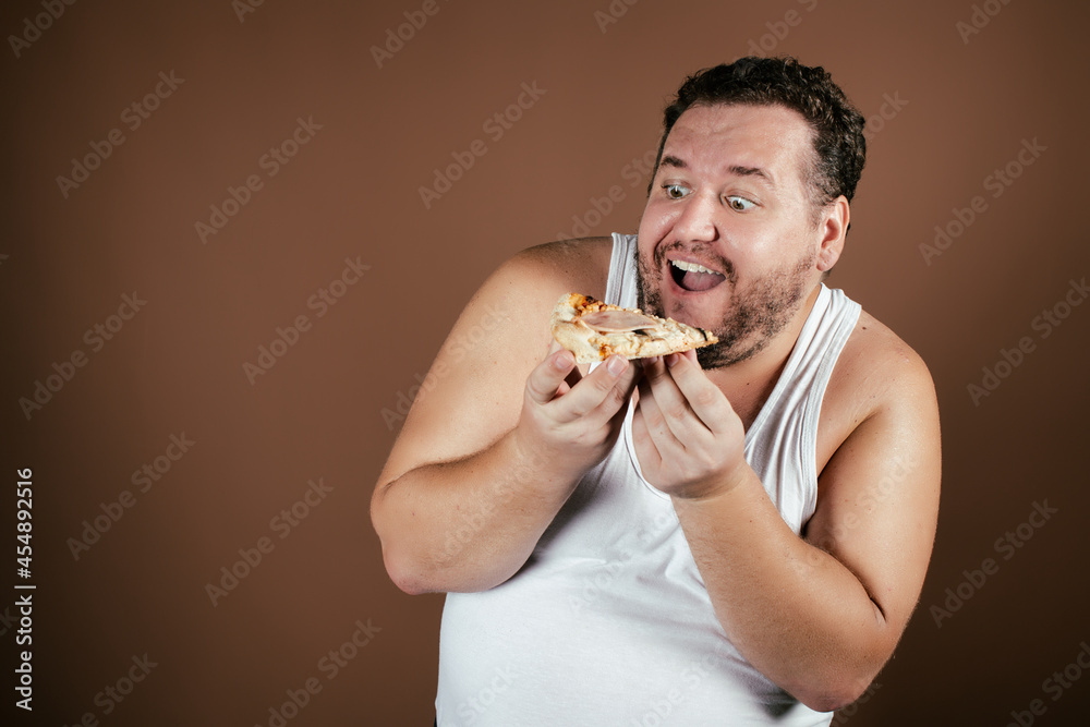 Funny fat man on a diet eats pizza. Funny fat man on a diet eats pizza.