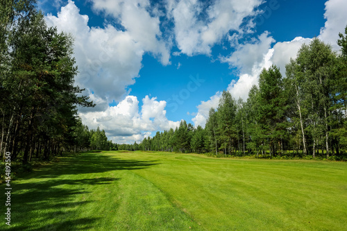 Panorama view of a Golf Course with fairway field. Golf course with a rich green turf beautiful scenery. High quality photo