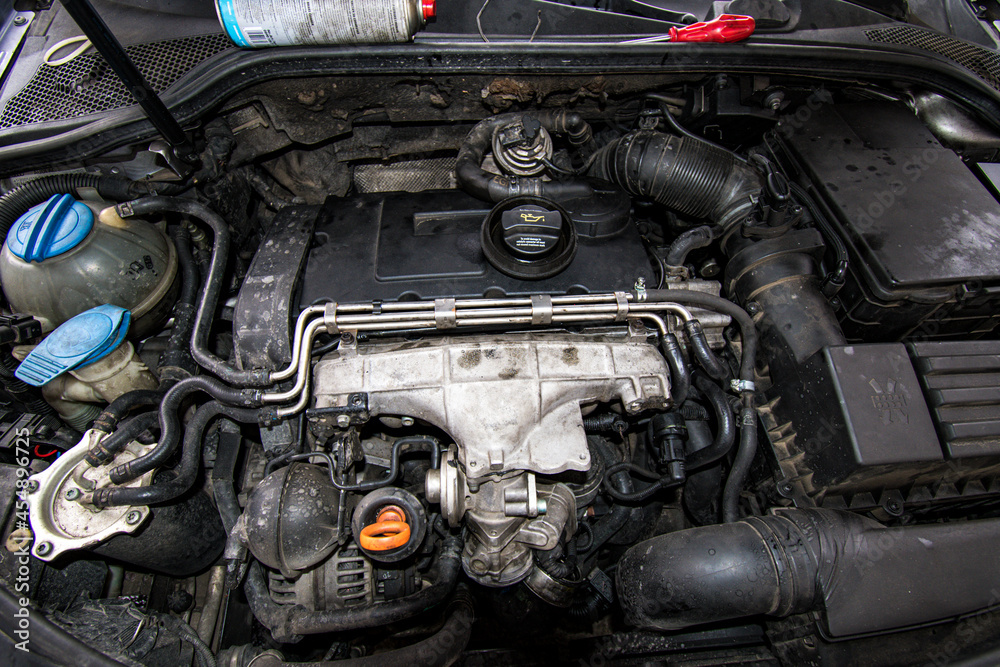 Open real car engines in the repair phase in a car mechanic shop Open real car engines in the repair phase in a car mechanic shop