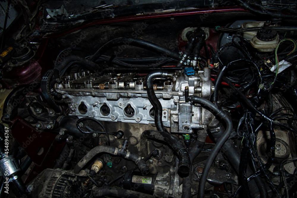 Open real car engines in the repair phase in a car mechanic shop Open real car engines in the repair phase in a car mechanic shop