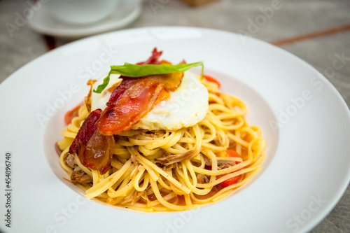 Spicy pulled pork linguine with bacon, cherry tomatoes and sunny egg on top.