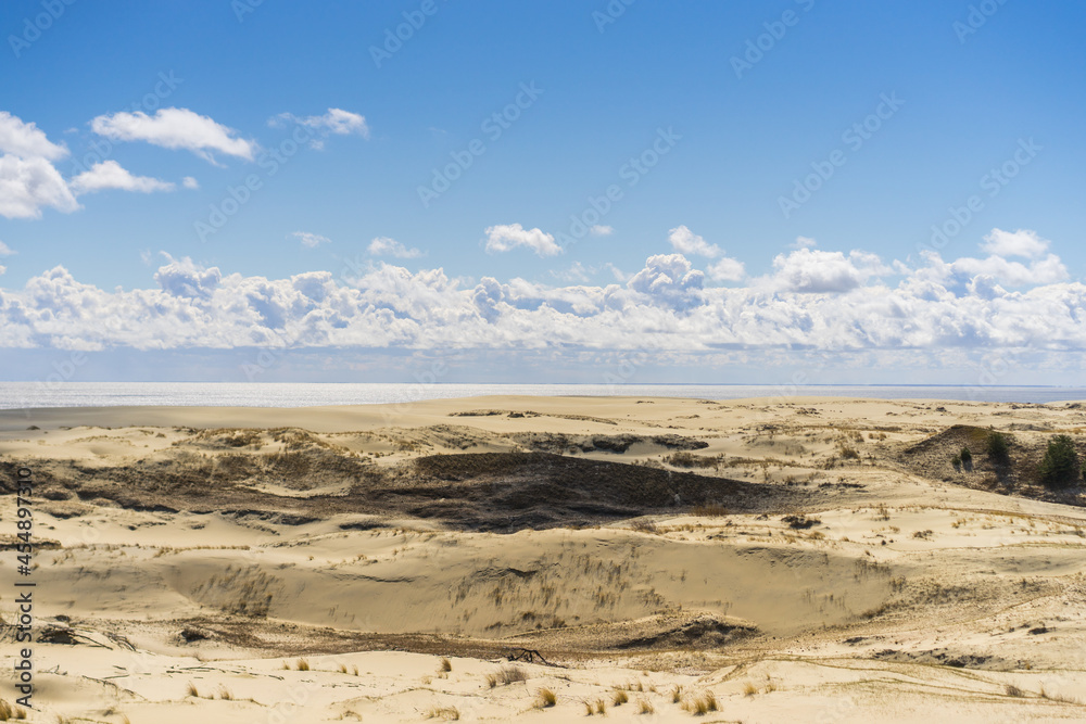 Coast of the Baltic Sea. Sand dunes with clouds. Typical Baltic beach landscape.