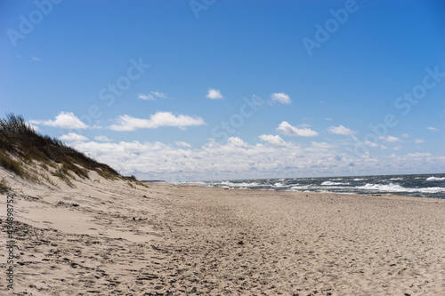 Coast of the Baltic Sea. Sand dunes with clouds. Typical Baltic beach landscape.