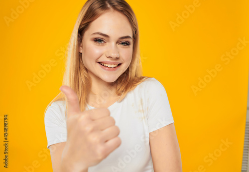 pretty woman in a white t-shirt hand gesture isolated background