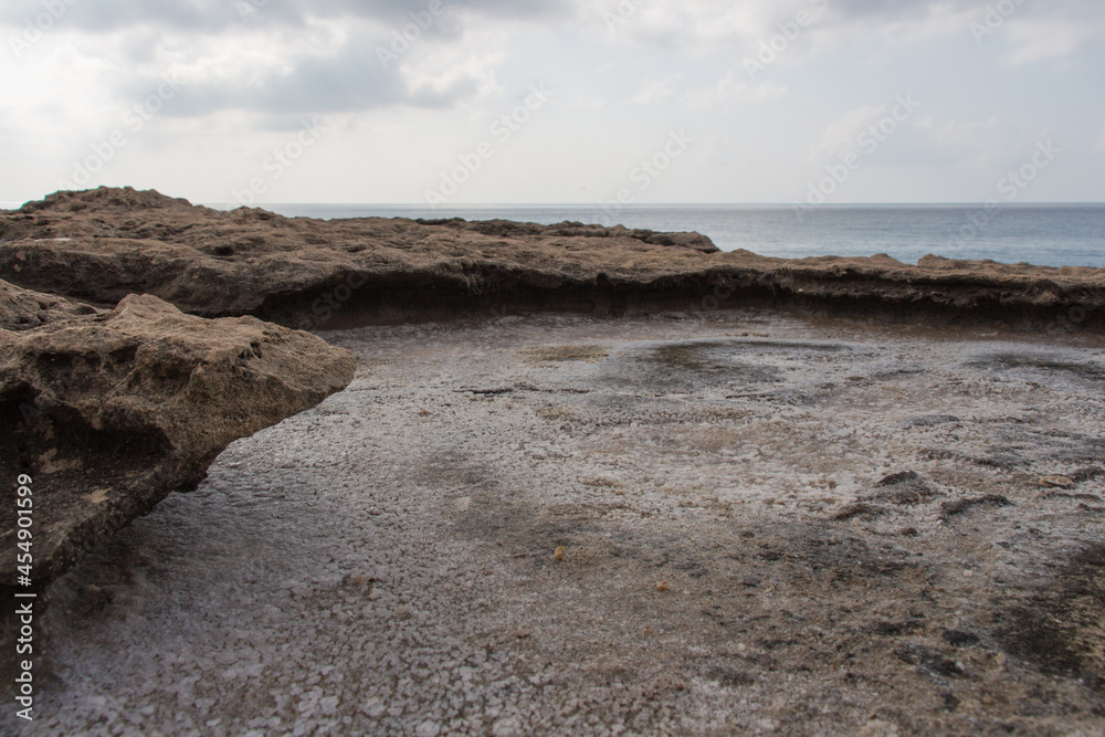 Crystallized salt in a rock hole after the sea water evaporated. Crystallized salt in a rock hole after the sea water evaporated.